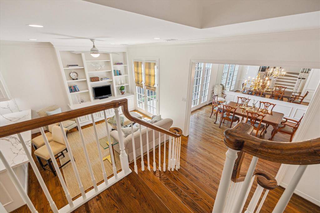 Staircase Landing - View down from the staircase landing shows edge of kitchen, den and dining room.