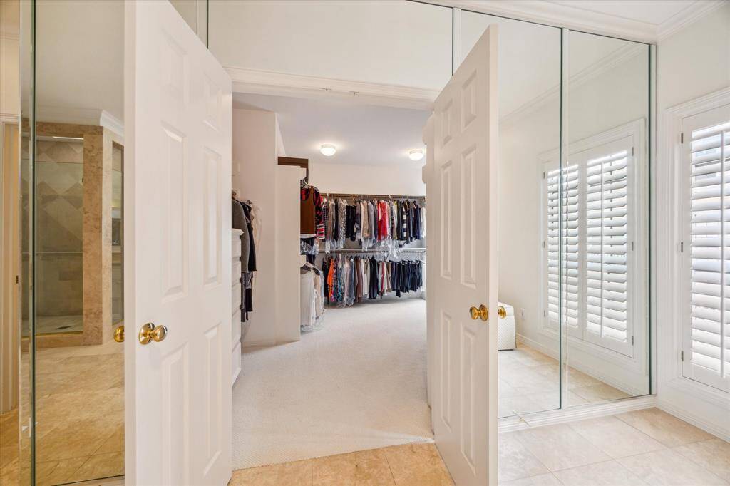 Primary Closet - One of two closets in the primary suite with custom built-in's.