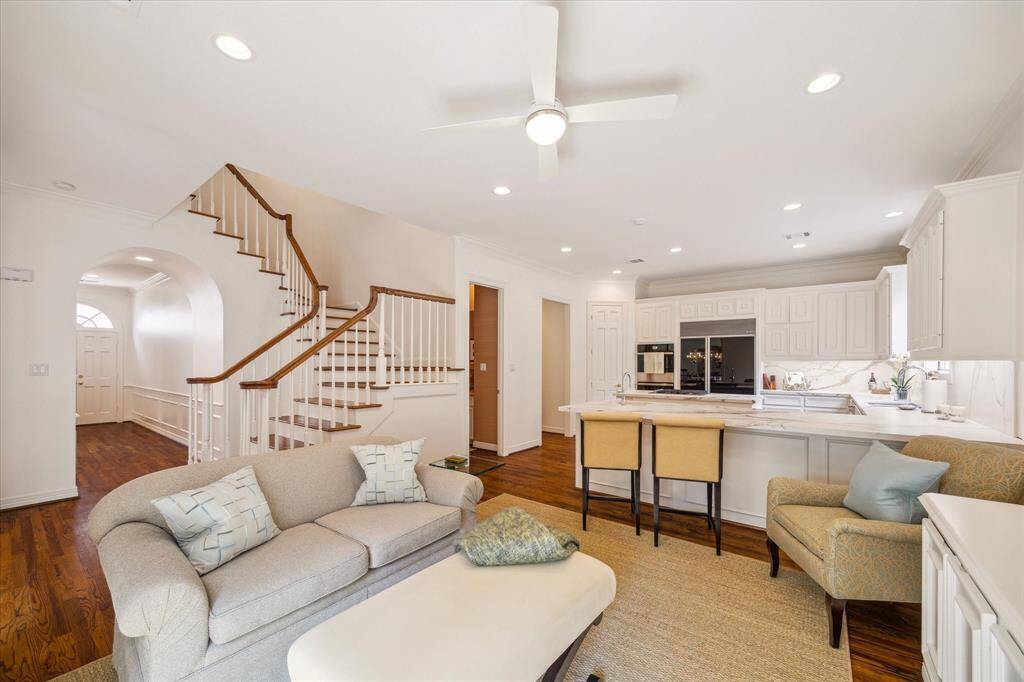 Den to Kitchen - An open kitchen with breakfast bar peers into a charming den with built-in's and French doors to the patio. Fresh and bright, turnkey updates make this gorgeous home move-in ready.