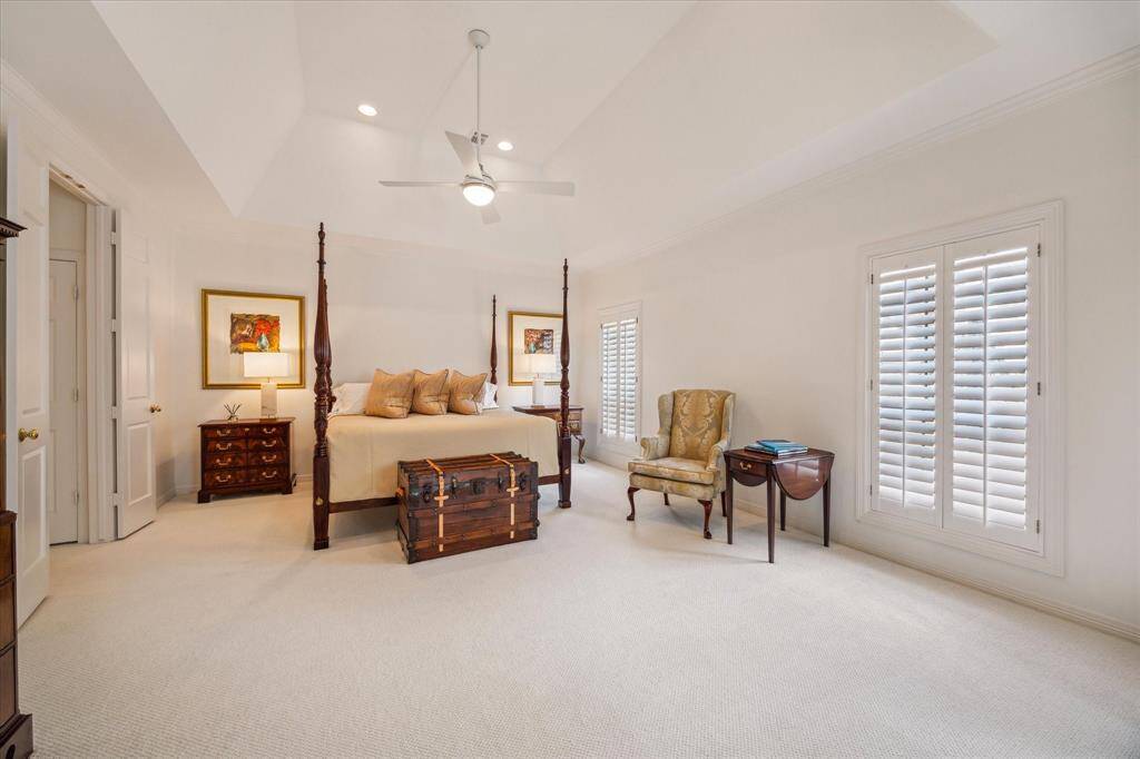 Primary Suite - Serene primary suite has vaulted ceilings, plantation shutters, spacious footprint, spa-like bath, amazing double closets and attached study/sitting room.