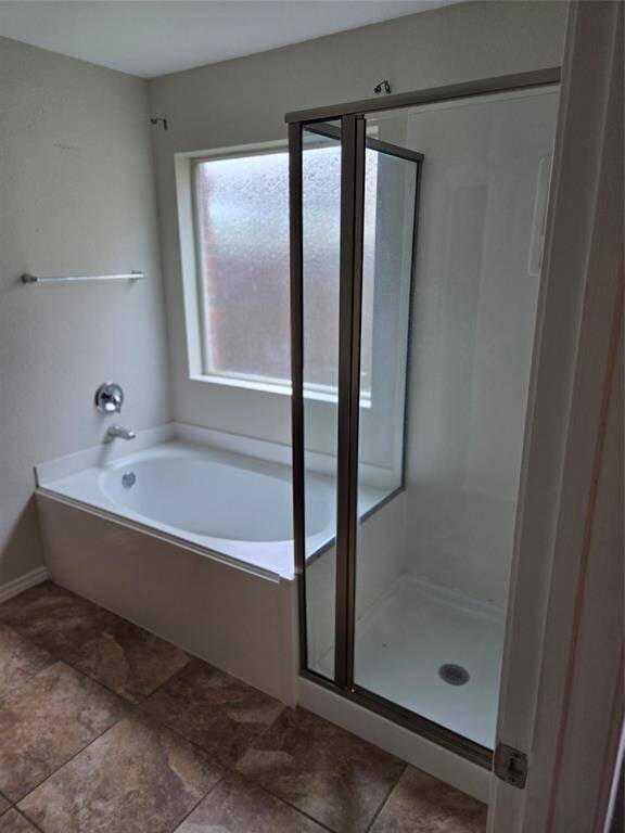 Primary bath ensuite with soaking tub and separate shower