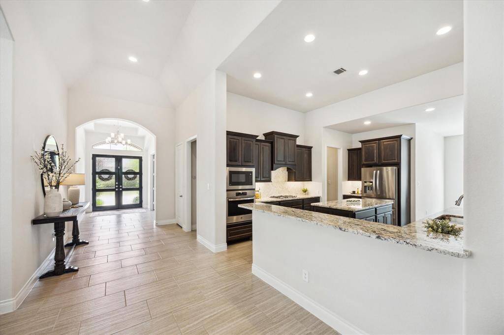 View of entry from hallway between dining room and kitchen