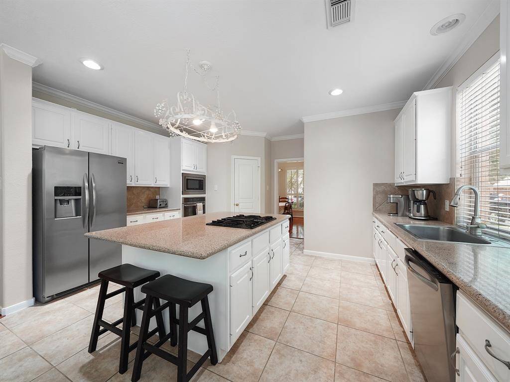 Welcome to your dream kitchen! This home boasts a stunning island kitchen with sleek white cabinets, Avanza countertops, and stainless steel appliances. The gas cooktop island is a chef's paradise, perfect for creating culinary masterpieces. Embrace modern living in this beautifully designed space!