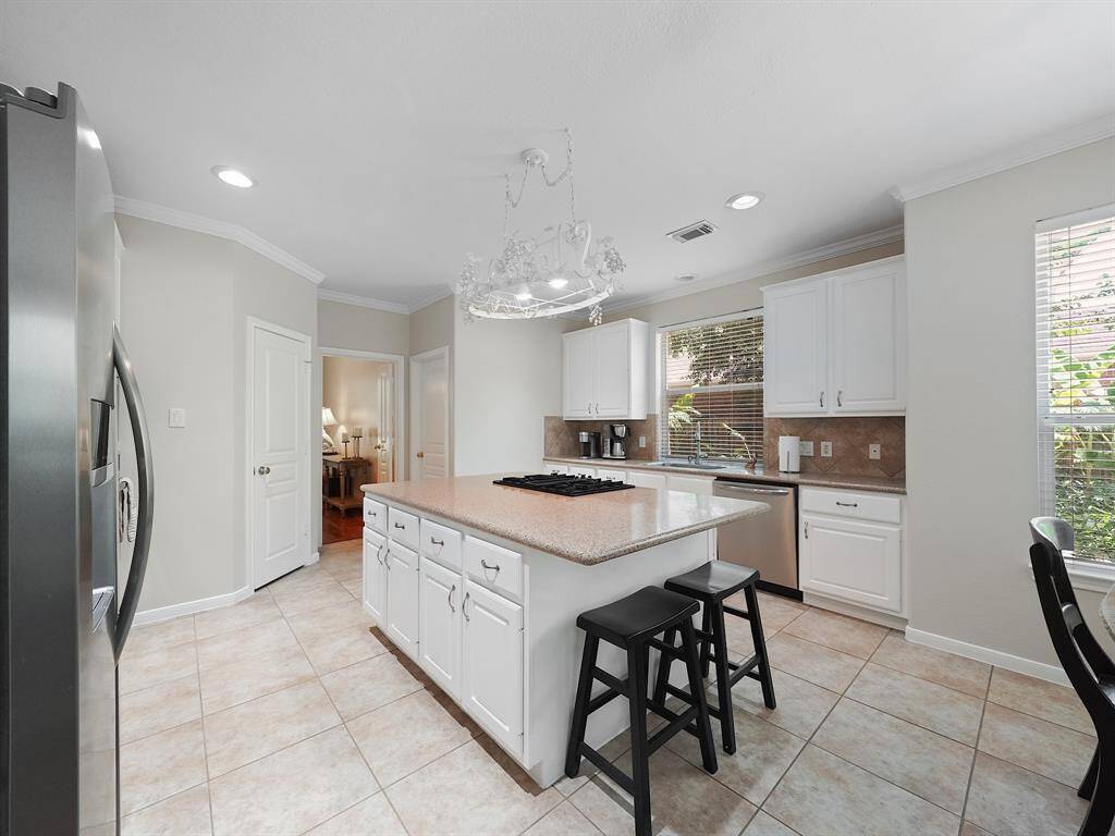 The kitchen features ample counter and cabinet space, plus a large pantry, making it perfect for storage and meal preparation.