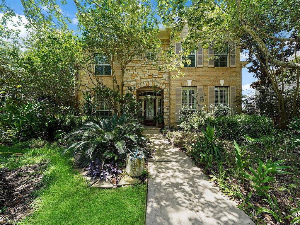 This home greets you with vibrant, lush landscaping, creating an inviting first impression that promises beauty and serenity within.