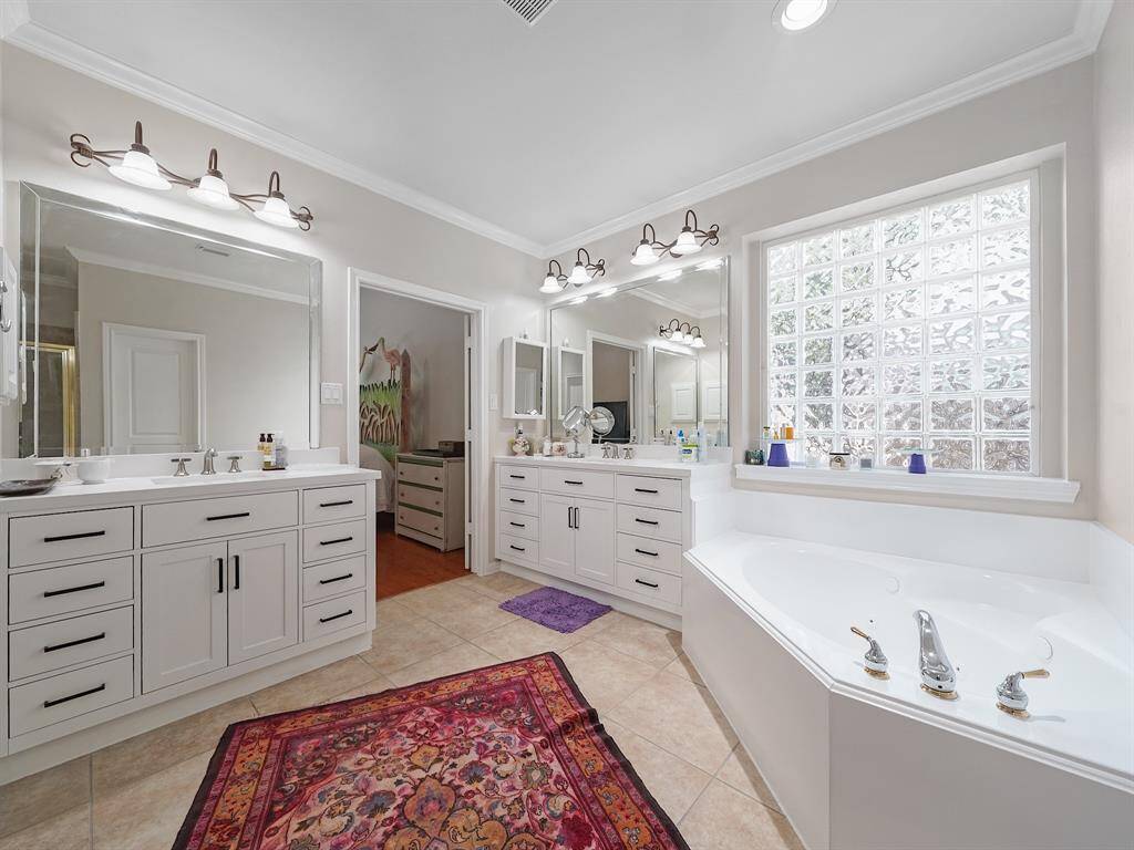Escape to the tranquility of the updated primary ensuite, complete with dual vanities, a soothing jetted tub, and a refreshing separate shower. Your personal oasis awaits.