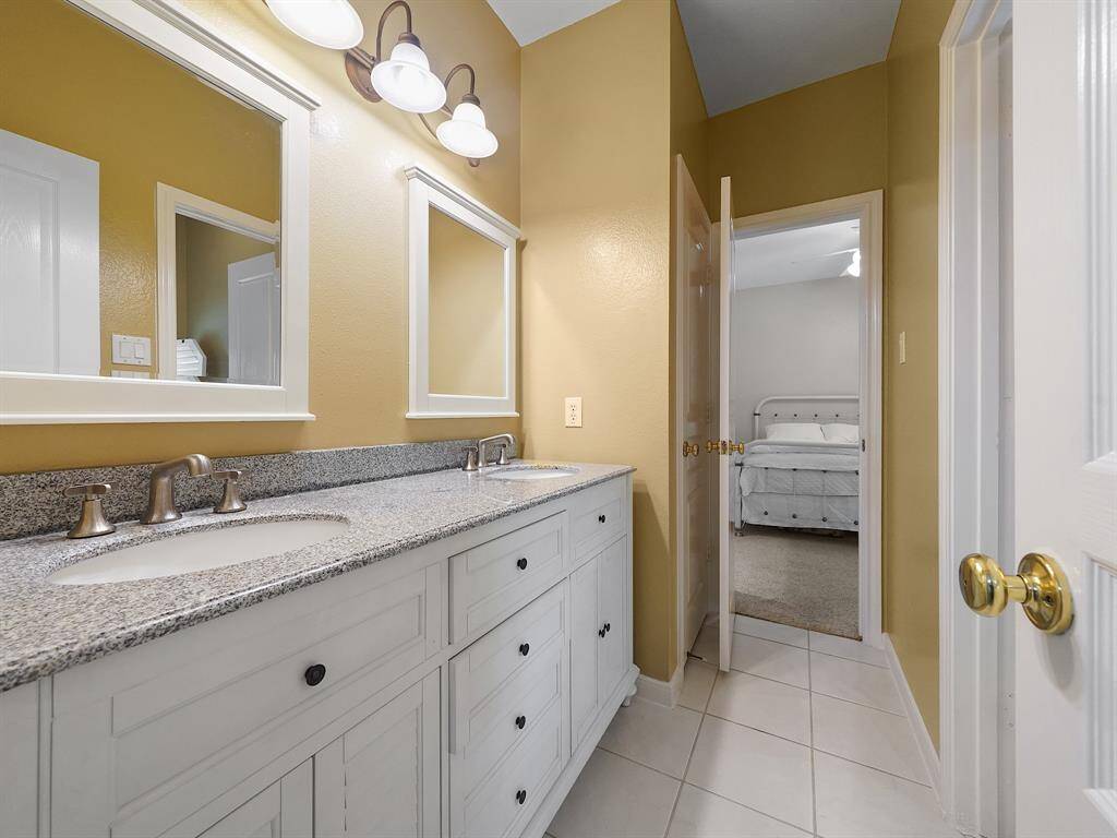 This home features a convenient Jack and Jill bathroom, shared by two comfortable secondary bedrooms. Enjoy the added convenience of dual sinks, perfect for busy mornings.