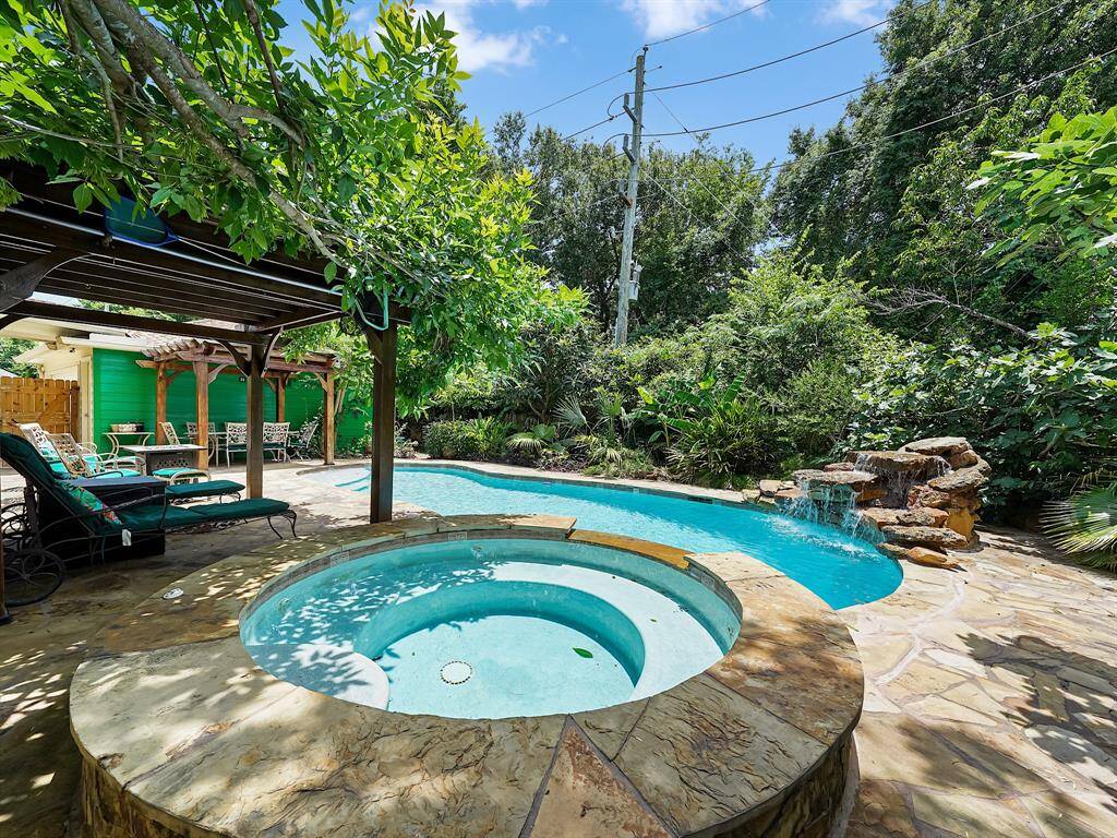 Escape to your private paradise! This stunning home boasts a lush, tropical garden as a backdrop to your sparkling pool, creating a serene oasis. Backing directly onto a tranquil bayou, enjoy unparalleled privacy with no rear neighbors.