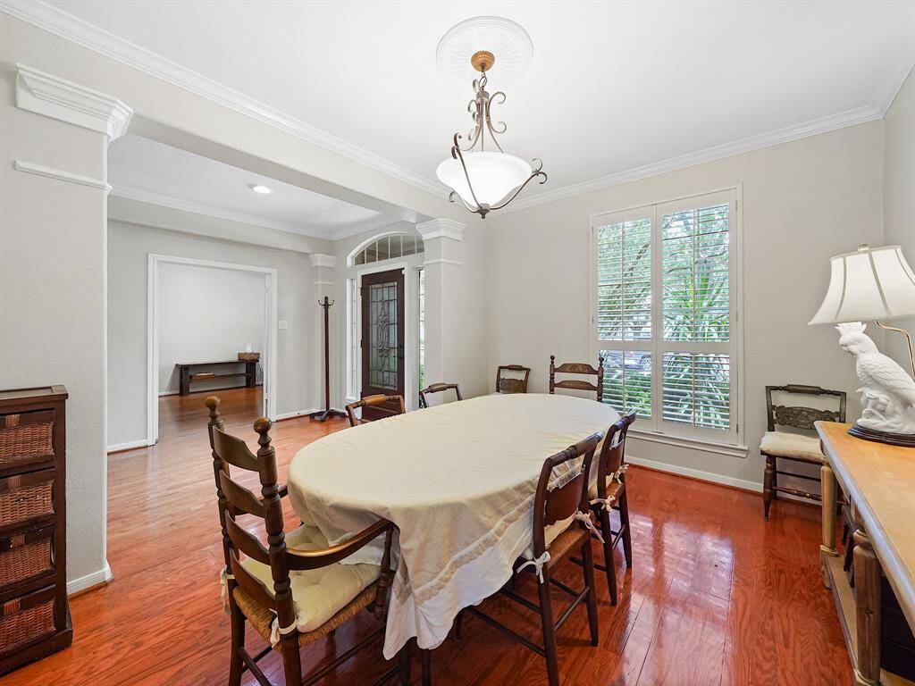 Entertain in style in this home's captivating formal dining room. Situated just off the entry, this space is bathed in natural light filtered through elegant plantation shutters, creating a warm and inviting atmosphere for family and friends.