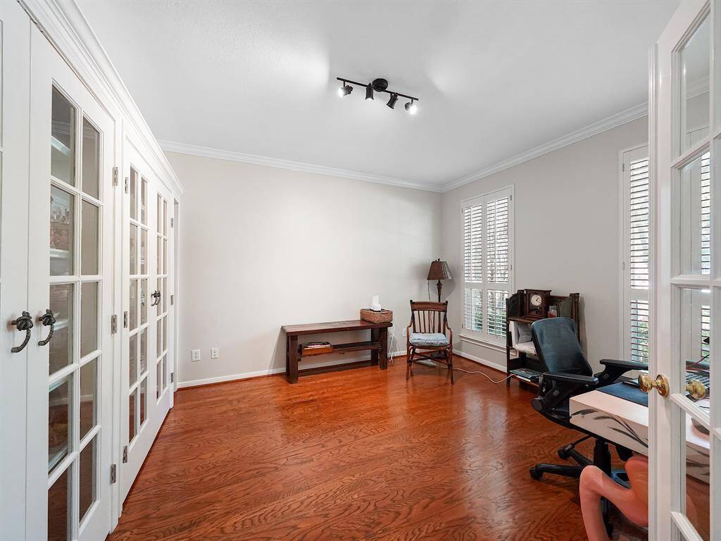 Step through the elegant glass French doors just off the entry and discover a private study, offering ample space for storage and a tranquil atmosphere perfect for focused work or quiet reflection.