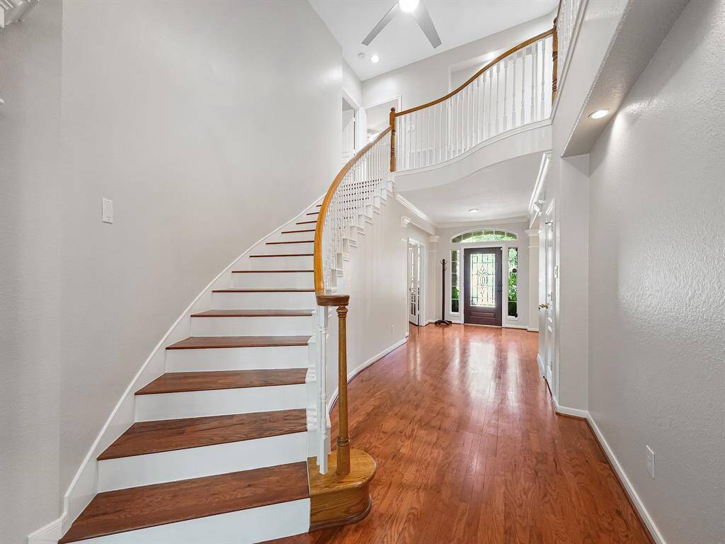 Stunning entryway has soaring ceiling and showcases the soft, neutral tones throughout the home!