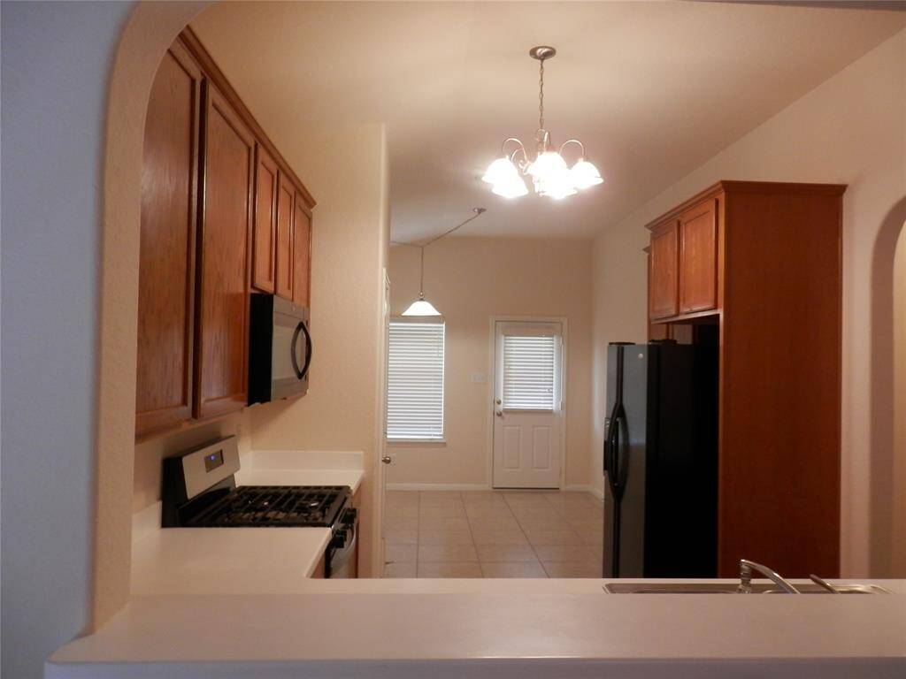 Kitchen offers microwave, gas range and refrigerator