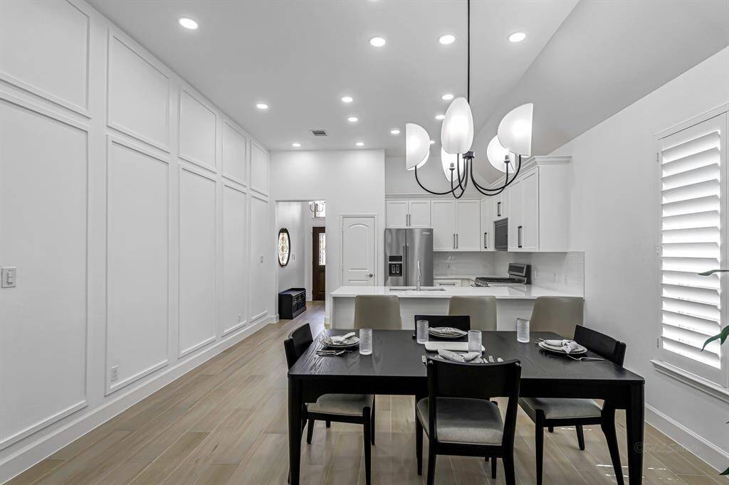 Anchored by an elegant chandelier, the dining space feels both refined and relaxed—perfectly positioned between the kitchen and living room for a truly open-concept experience.