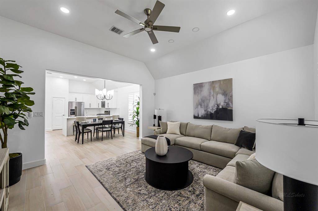 The family room serves as the heart of the home, effortlessly connecting to the kitchen and dining areas in a seamless, open-concept layout. Its spacious design allows for easy movement and conversation, making it ideal for both entertaining and everyday living.
