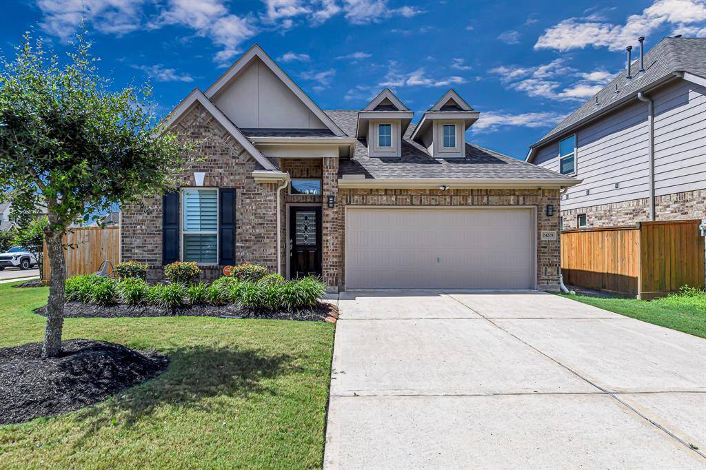 Welcome home to 24203 — A picture-perfect blend of charm and comfort. This lovingly maintained brick home features beautiful curb appeal, with a manicured lawn, lush landscaping, and a welcoming front porch.