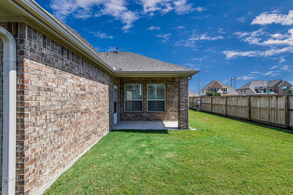 The spacious backyard features a beautifully manicured lawn that’s ready for play, pets, or gardening. Just off the lush green space, the covered patio offers the perfect spot to unwind or entertain while enjoying the peaceful view of your private outdoor retreat.