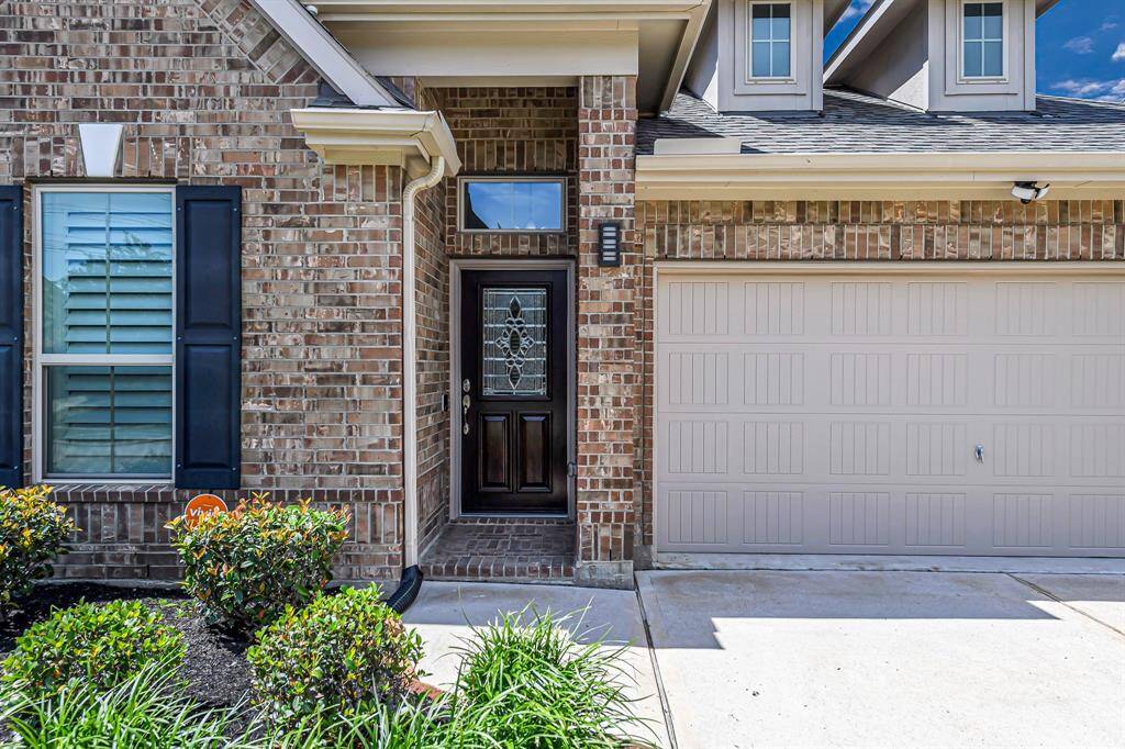 Step up to a warm welcome with this charming covered front porch, perfect for greeting guests or enjoying a quiet moment outdoors. The elegant front door features a beautifully detailed glass design that adds character and curb appeal, setting the tone for the inviting space that awaits inside.