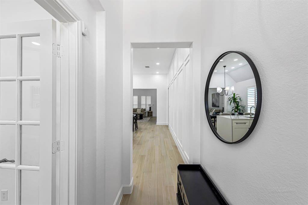 Step inside and instantly feel at home. This bright and elegant entryway sets the tone with its warm porcelain hardwood tile flooring, clean architectural lines, and abundant light. The thoughtful design welcomes you with style and grace, offering a first impression that’s both sophisticated and inviting.