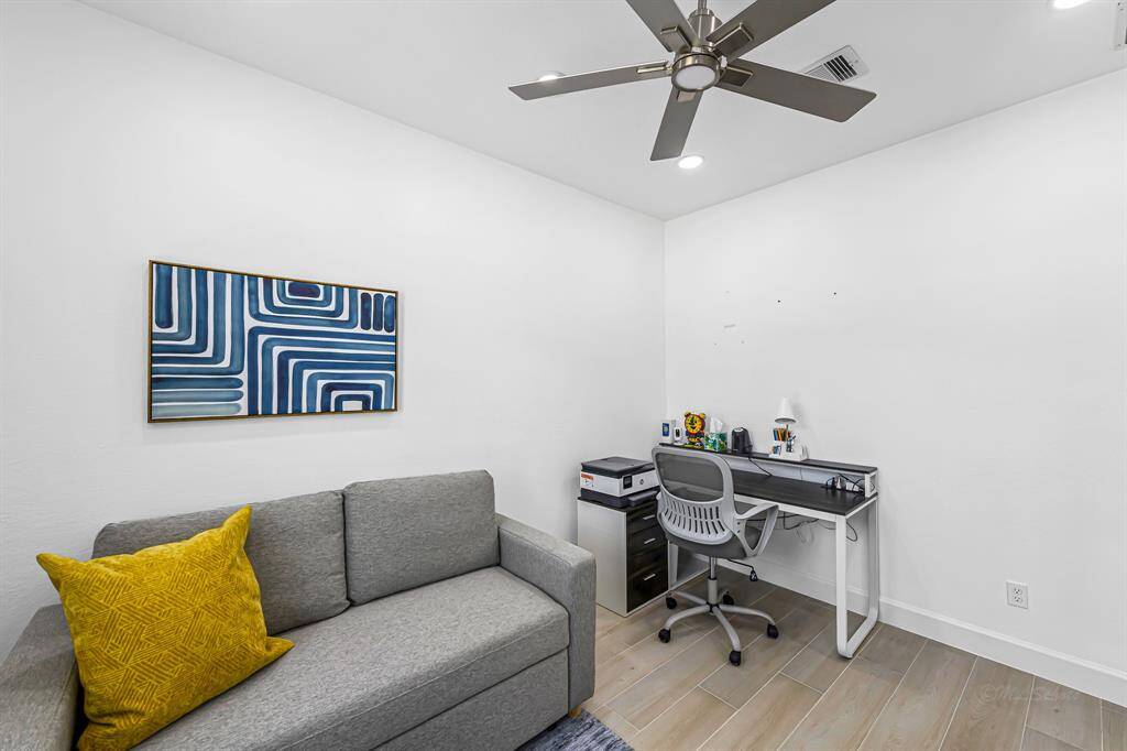 Here’s another look at the charming home office—smartly designed with comfort and productivity in mind. The upgraded LED lighting keeps the space bright and energy-efficient, while the modern ceiling fan ensures a comfortable environment year-round. Whether you're working from home or tackling creative projects, this flexible room offers a peaceful, well-lit setting to stay focused.