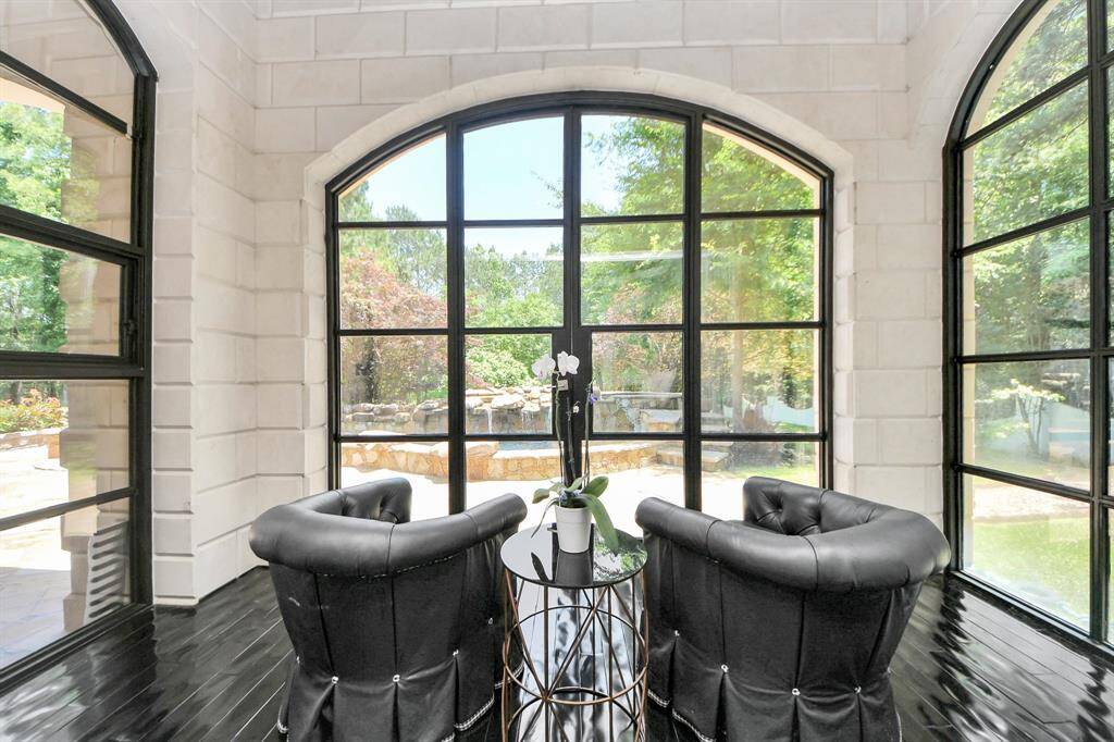 Spacious primary suite with an attached sunroom, perfect for relaxation and enjoying natural light.