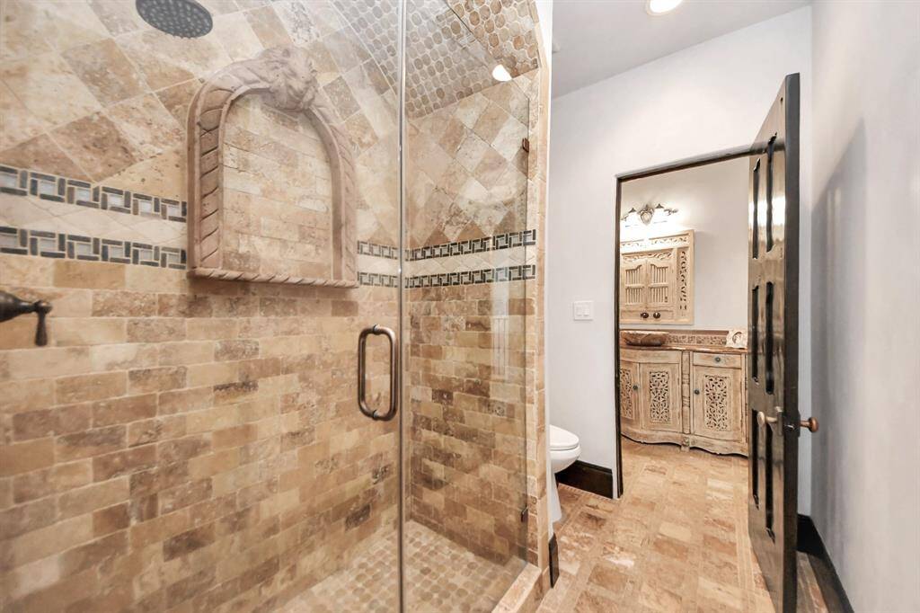 Experience the convenience of a Jack and Jill bathroom featuring a stunning custom shower.
