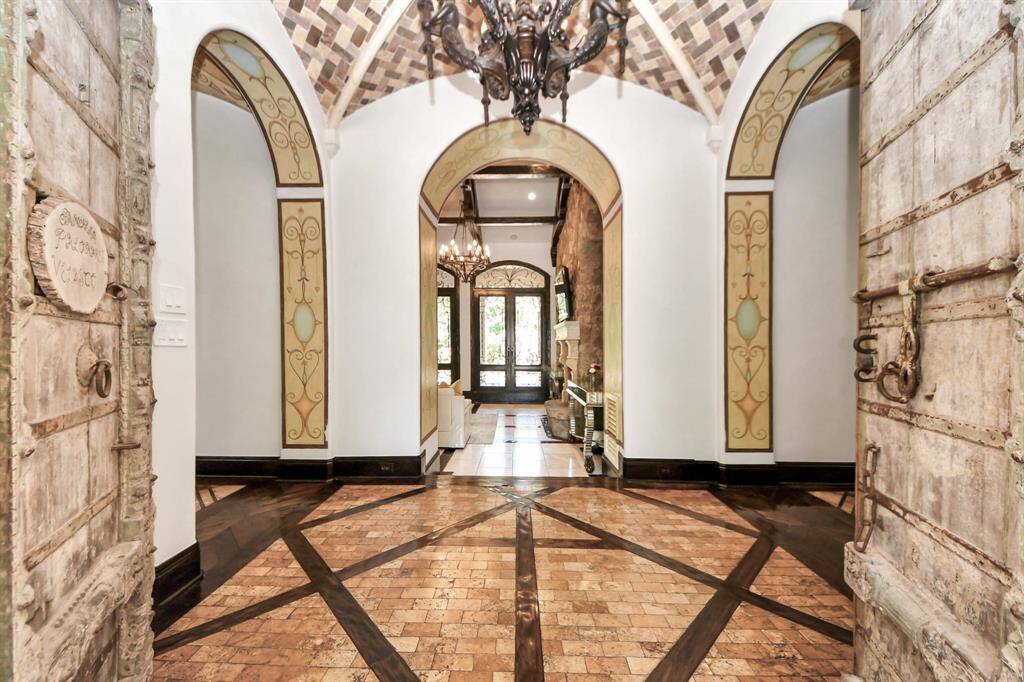 Discover this stunning custom home featuring high ceilings and elegant archways. Enjoy luxurious tile, stone, and wood flooring throughout.