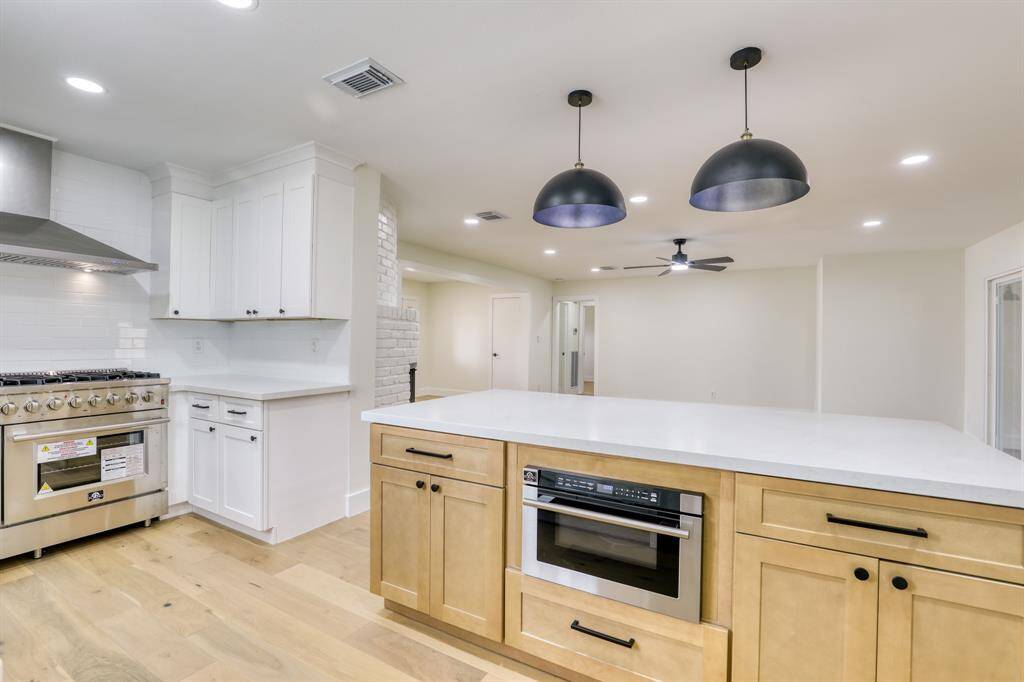 Island has even more storage and large microwave with sliding drawer.