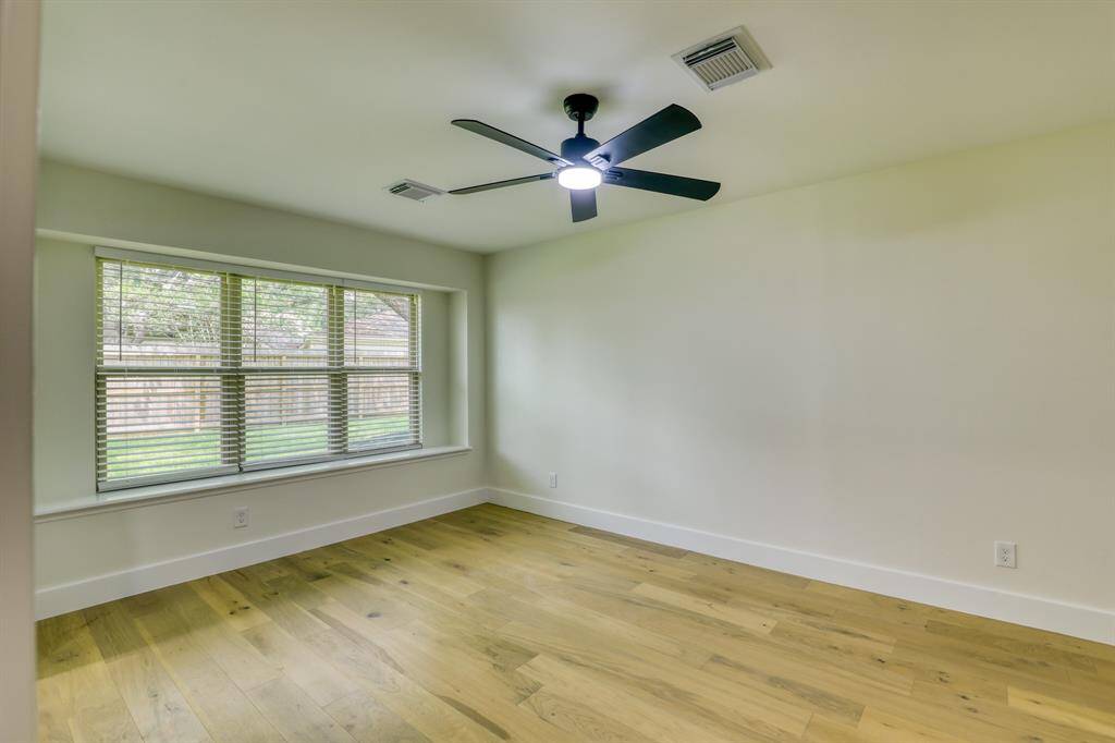 Primary bedroom with seating by window