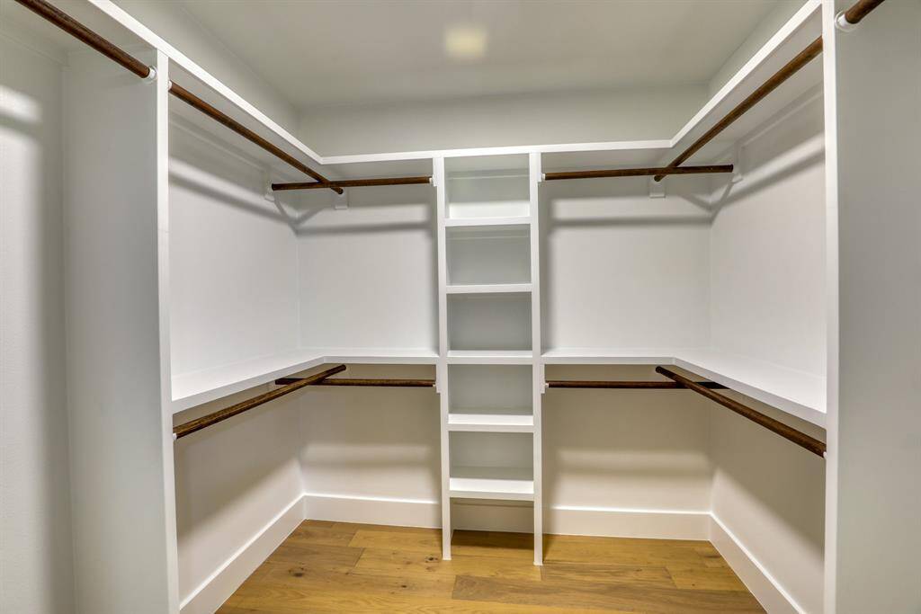 Primary walk in closet with built ins