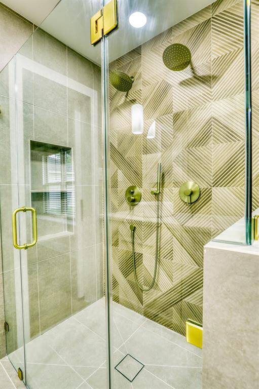 Primary en suite walk in shower with dual heads