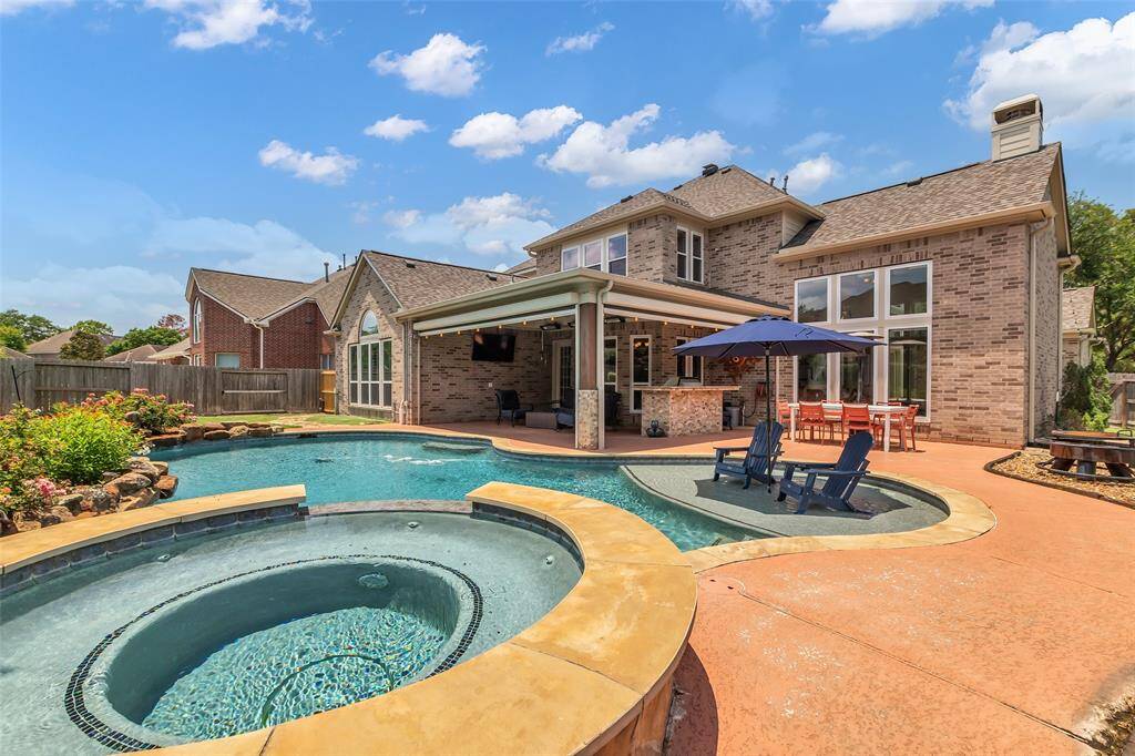 Large pool graded for volleyball with attached ten person spa