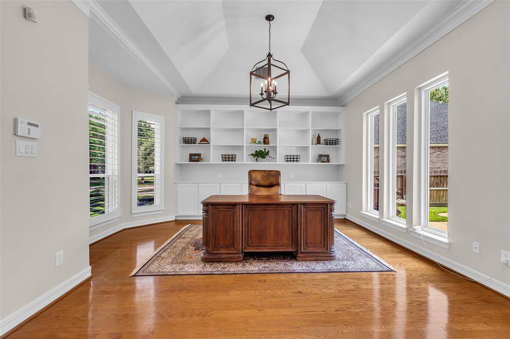 Office with built in shelves and cabinets for ample storage