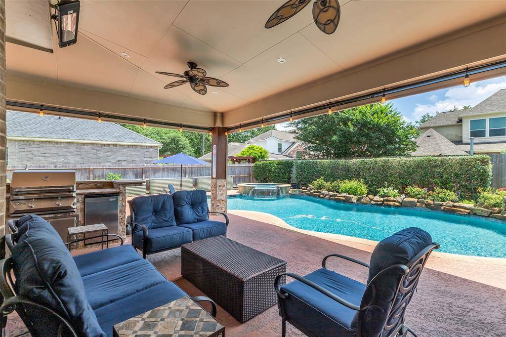 Covered Patio with outdoor Kitchen and electric shades