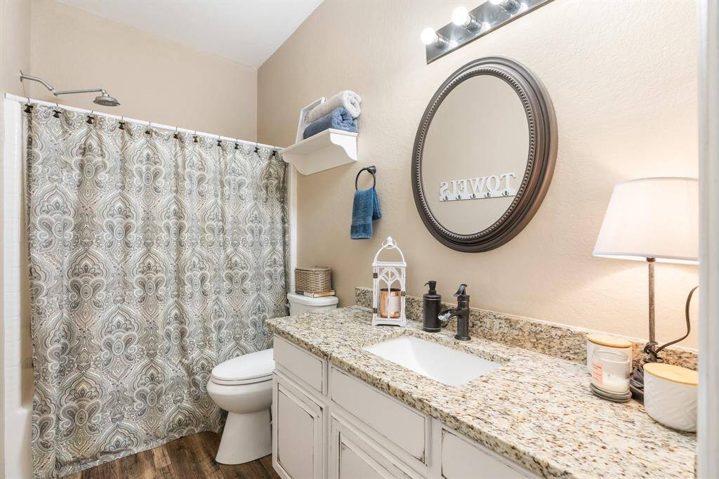 guest bath, tub/shower combo. Granite coutertops & bronze faucets updated in 2023