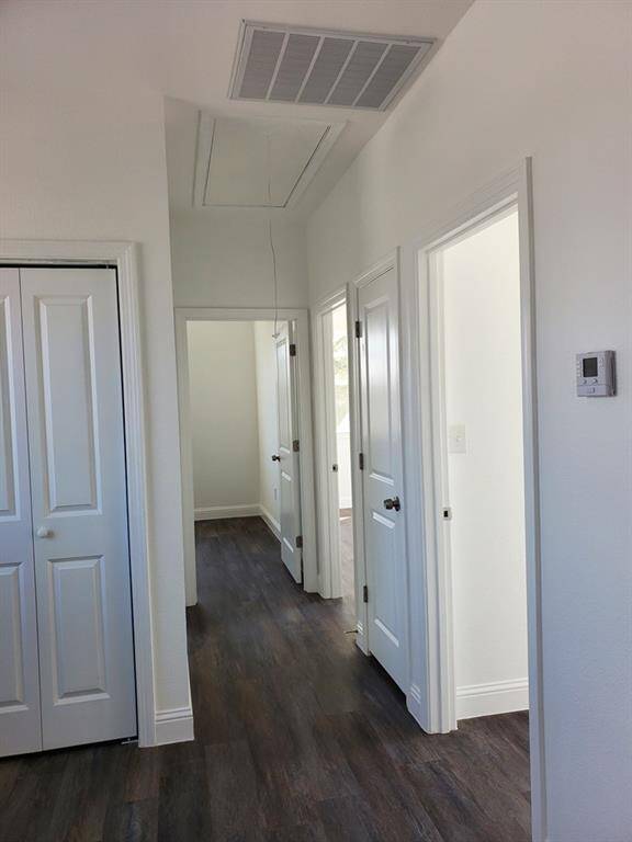 garage with a side door to access back patio as well as emergency exit