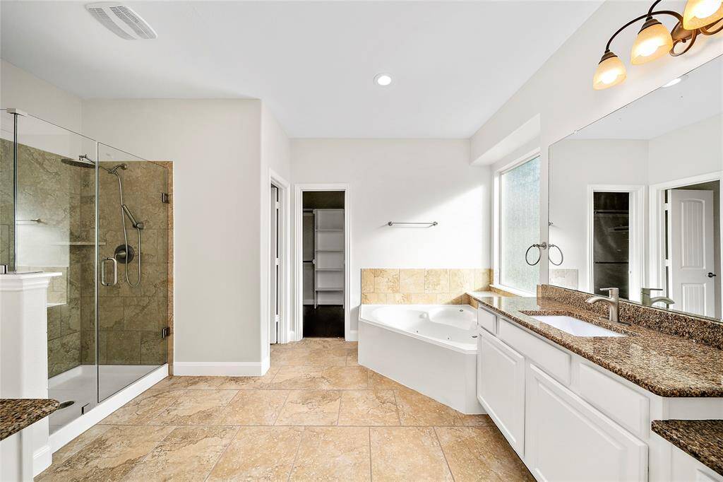 Primary bath with separate frameless glass shower as well as the jetted tub.