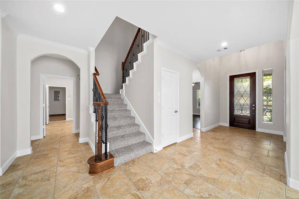 Stairs are tucked away installed with new carpet throughout upstairs.
