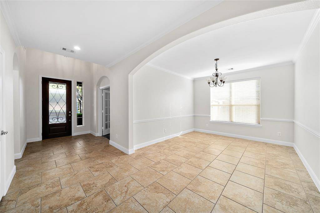 Spacious foyer area with front office as well as the secondary primary bedroom at the front of the home.