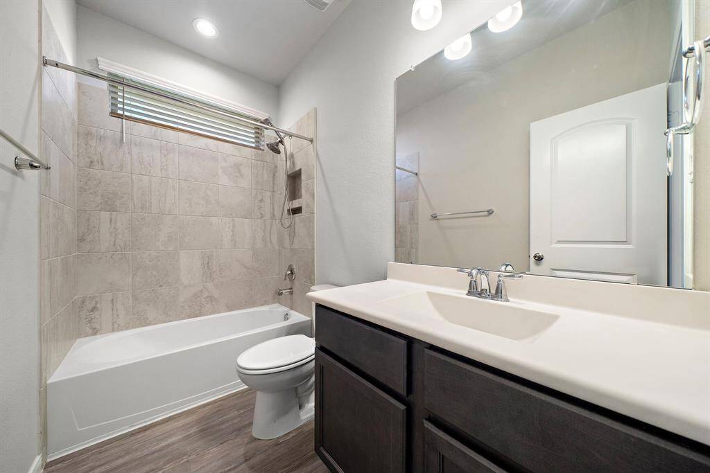Bathroom One is conveniently located between Bedroom One and Bedroom Two, offering easy access for both rooms. The bathroom features solid countertops and a tub and shower combo.
