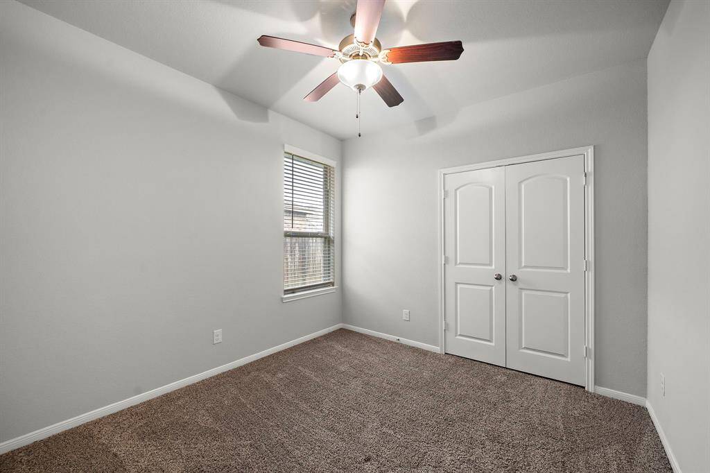 Bedroom Three is located towards the front right of the home, offering privacy and a quiet retreat. This spacious room features its own private bathroom, making it an ideal suite for guests or a master bedroom alternative.