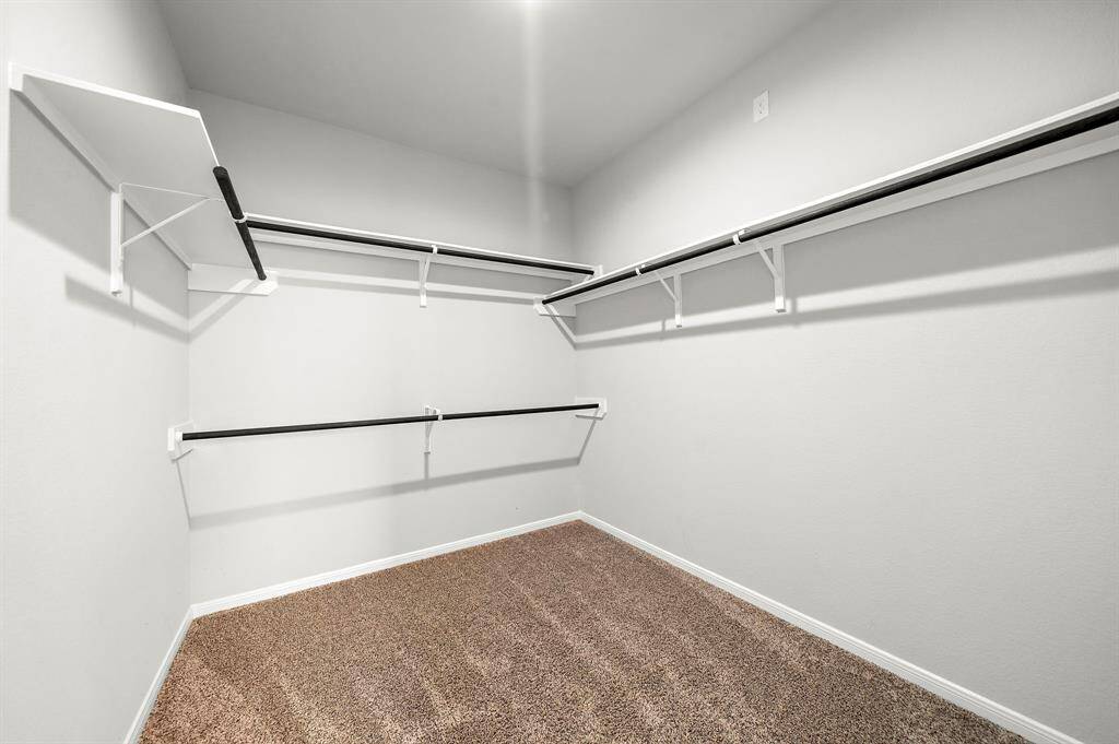 The primary bedroom features a spacious walk-in closet, offering plenty of room for all your clothing and accessories.