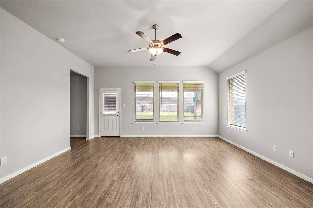The large, open family room is conveniently located just off the kitchen, creating an ideal flow for daily living and entertaining. With plenty of space for larger furniture pieces, this room is perfect for hosting gatherings or simply relaxing with family. The open layout ensures a bright and airy atmosphere, making it a welcoming hub of the home.