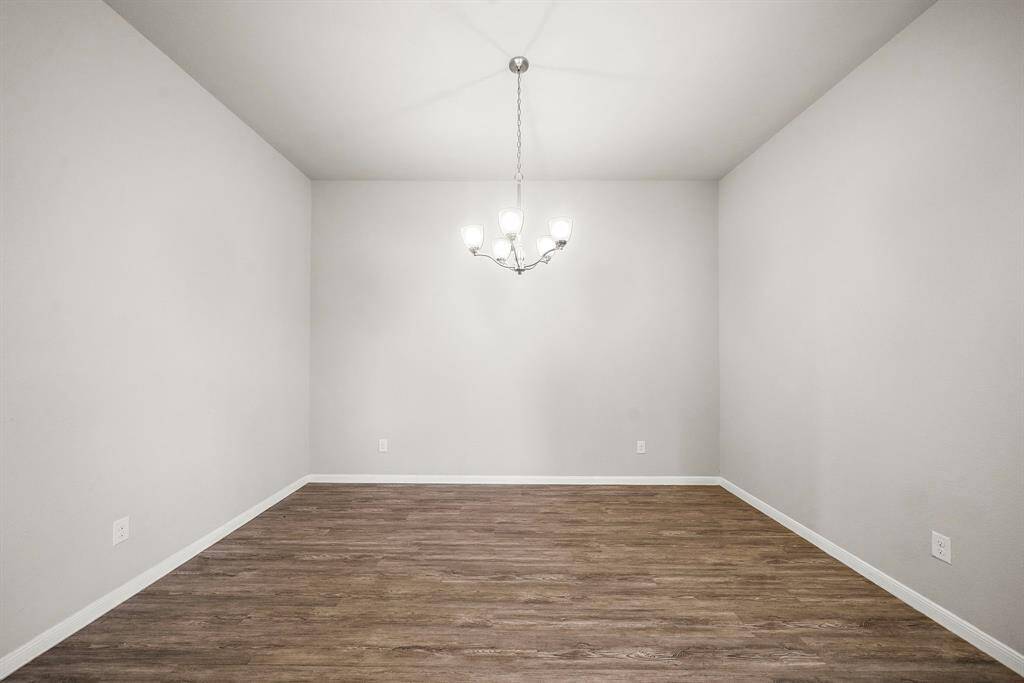 The large breakfast area, located right off the kitchen, offers plenty of room for a dining table, making it versatile enough to serve as a formal dining space if desired.
