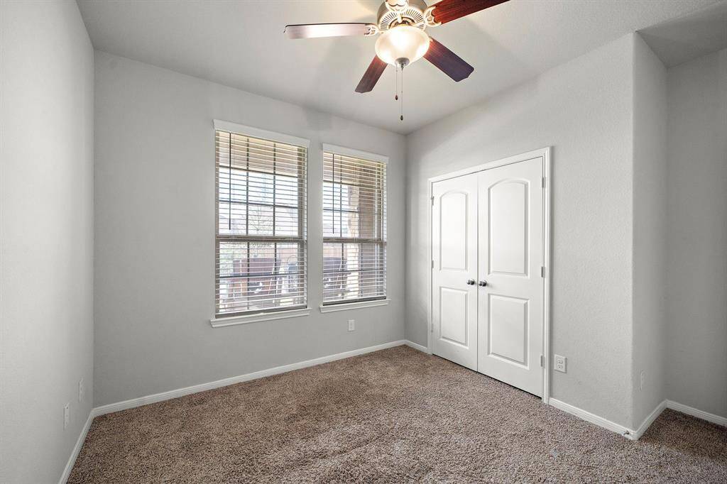 Bedroom One is located just off the entry, offering a spacious retreat with plenty of room. This room is bright and inviting, making it perfect for a guest room, home office, or cozy bedroom.