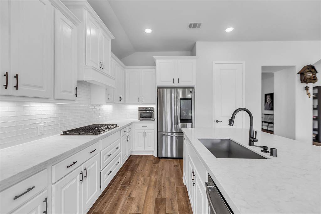 Adjacent to the kitchen is a cozy breakfast nook, a delightful spot to enjoy a morning coffee or a casual meal.