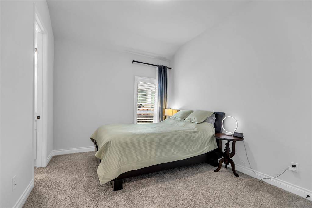 The spacious primary suite is a tranquil haven!  Expansive windows frame stunning views of the serene waterfront and the treed landscape beyond, creating a seamless connection between indoor comfort and outdoor splendor.