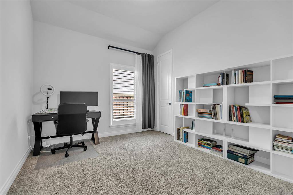 Bedroom 2 boasts stunning vaulted ceilings that create an airy and spacious ambiance. Positioned within a secondary hallway alongside Bedroom 3, it offers both accessibility and a sense of exclusivity, making it an ideal space for relaxation and comfort.
