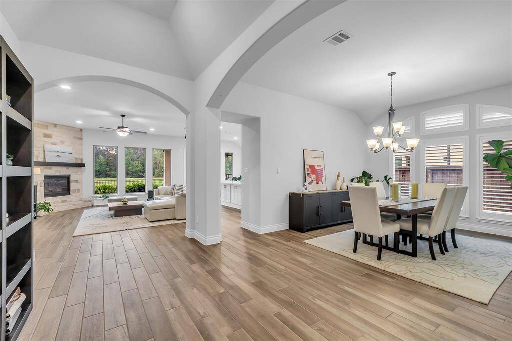 The dining room is a sophisticated yet welcoming space, designed to accommodate both intimate meals and larger gatherings.  This room becomes the perfect setting for memorable dining experiences and conversations.  Graced with plantation shutters and a beautiful chandelier, this sets the tone for the remainder of this home.