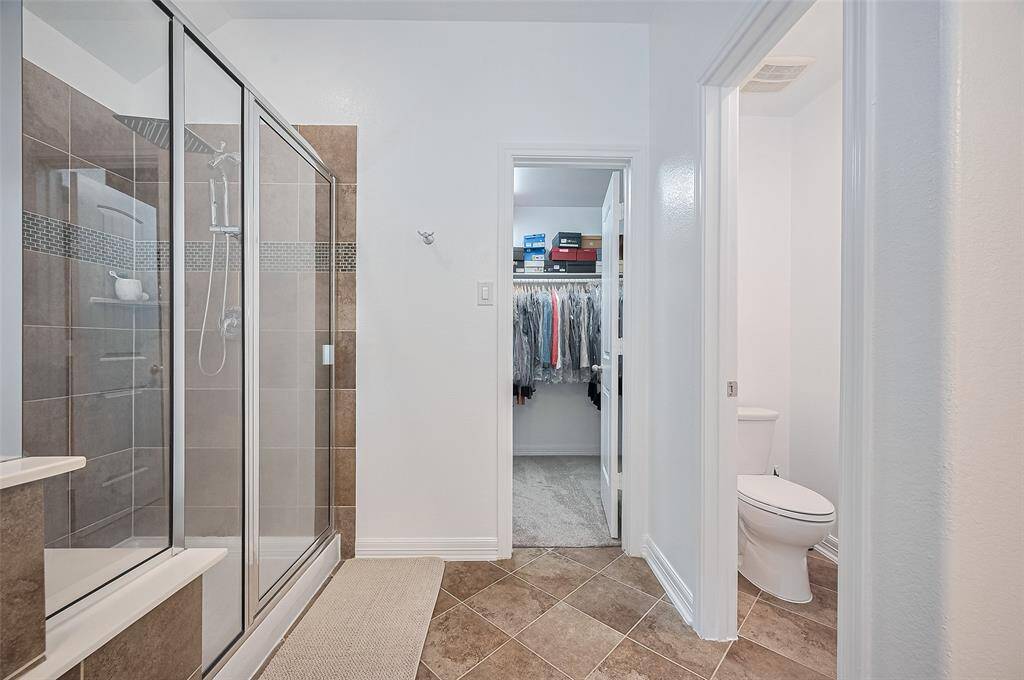 Beyond the threshold, the bathroom layout offers intuitive flow—complete with a private water closet and access to a full-entry closet.