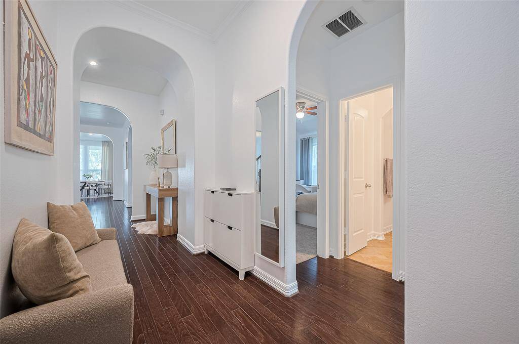 A series of graceful archways gently draw the eye forward, creating a soft rhythm through the home’s interior and offering glimpses of the inviting spaces that await beyond.